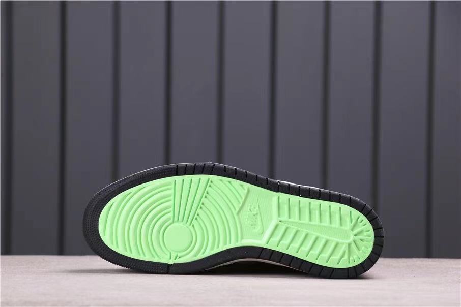 Outsole view showing a bright green traction section surrounded by black rubber.