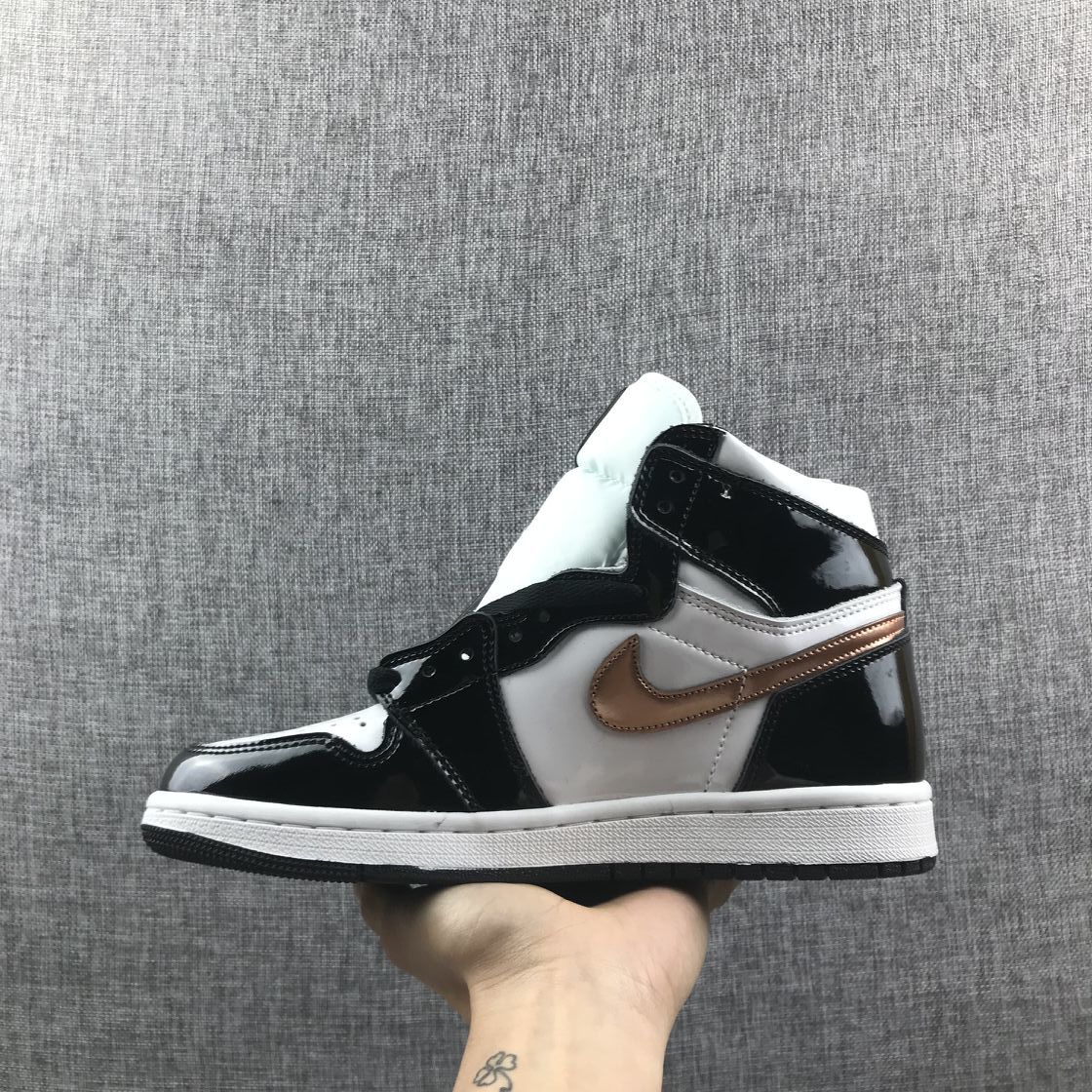 Side view showing the black patent-style overlays, white panels and metallic-gold Swoosh.