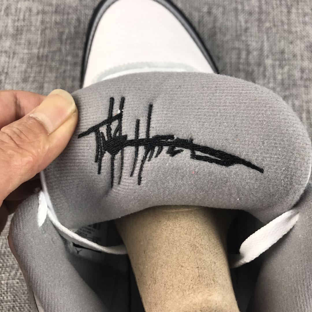 Close-up of the grey tongue lining with a black script-style mark.