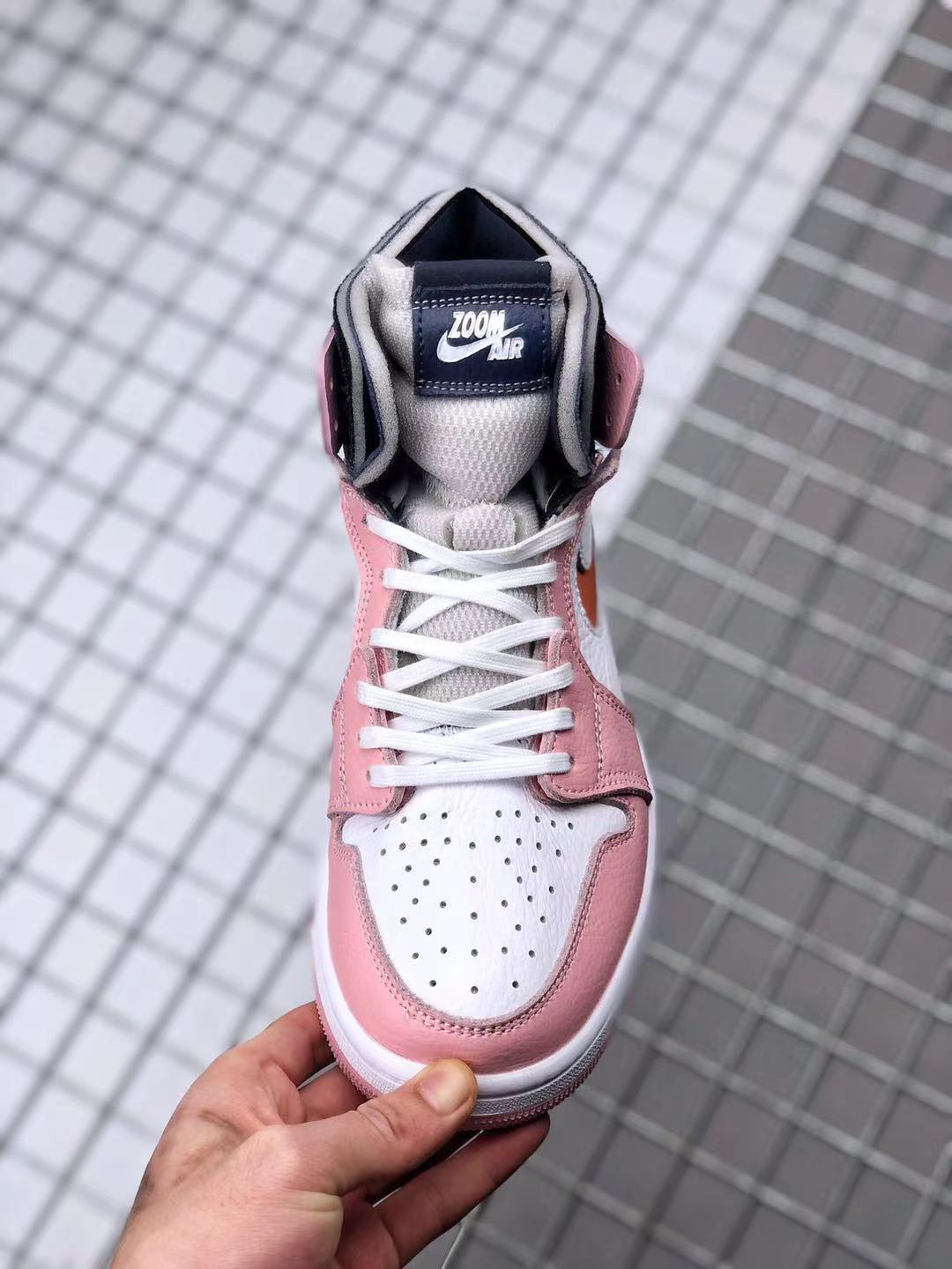 Top-front view showing the perforated white toe box, white laces, padded collar, and tongue label.