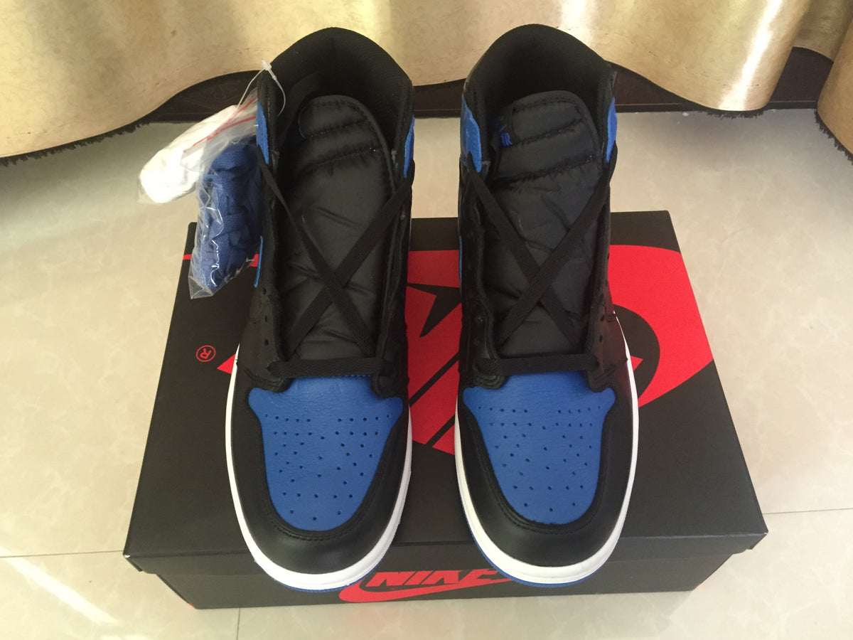 Top-down view showing the padded black tongues, black laces and perforated blue toe boxes.