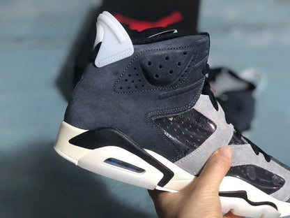 Close side view showing the perforated ankle panel, light grey overlay, black detailing, and visible heel air unit.