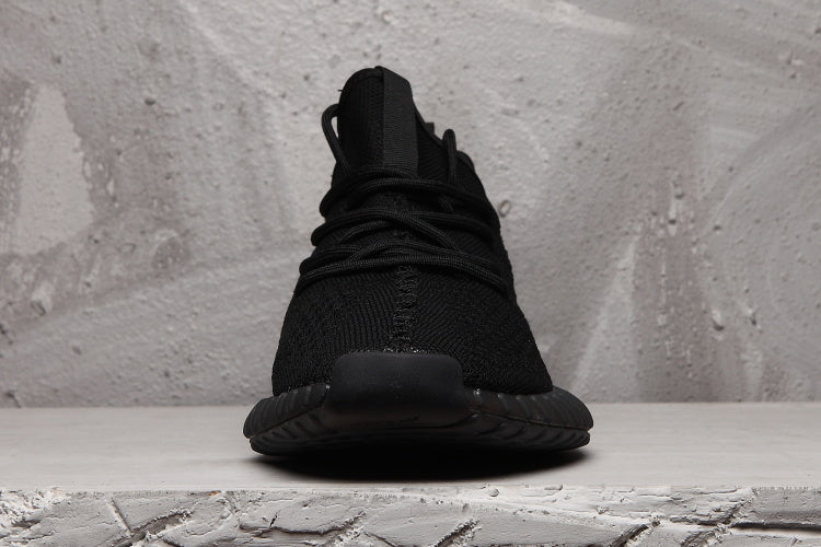 Front view showing the tongue, black laces, rounded toe, and dark outsole.