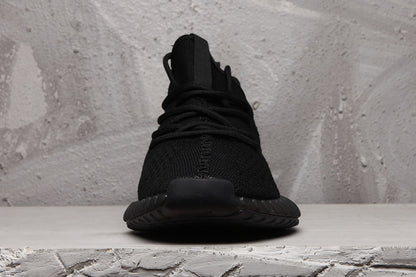 Front view showing the tongue, black laces, rounded toe, and dark outsole.