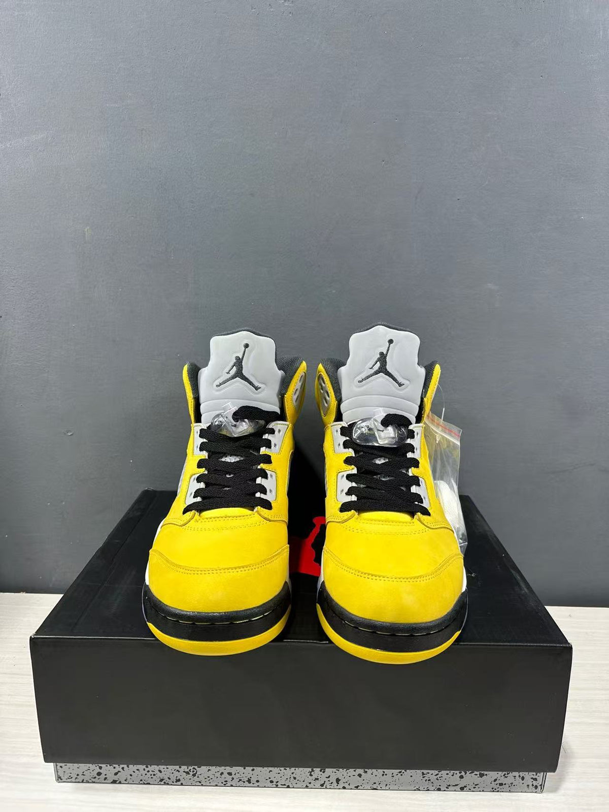 Front view of the pair showing black laces, gray tongues, and Jordan logos.