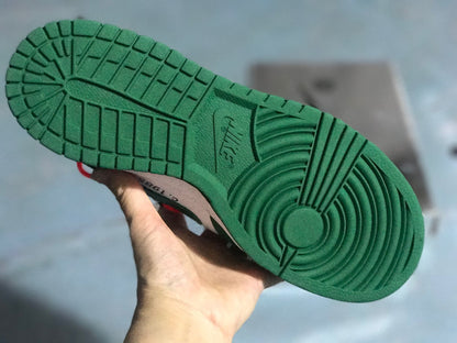 Close-up of the green outsole showing its segmented tread and circular forefoot traction pattern.