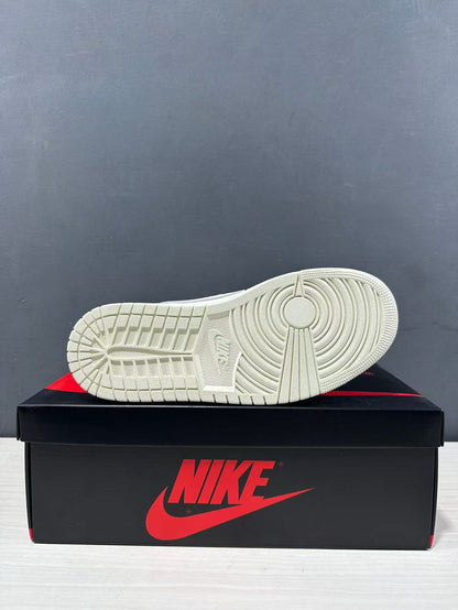 Underside view of a white sneaker showing the circular traction pattern and segmented outsole tread.