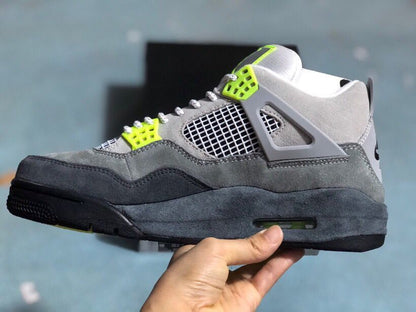Lateral side view highlighting the grey layered upper, mesh panel, lace wing, and black midsole.