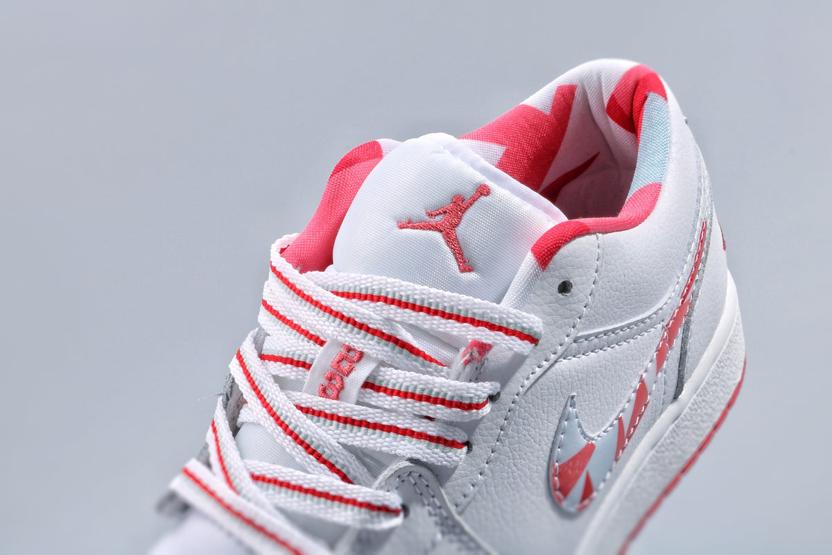 Close-up of the tongue, striped laces, pink-red collar lining, and Jordan tongue logo.