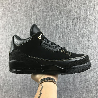 Side view of a black Jordan Air Jordan 3 BHM sneaker with gold accents