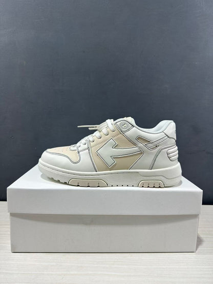Side profile of a cream-white low-top sneaker with layered upper panels and a thick rubber sole.