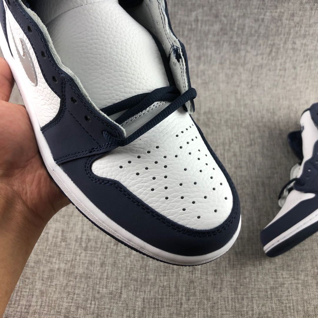 Top-down view of the perforated white toe box with navy surrounding overlays.