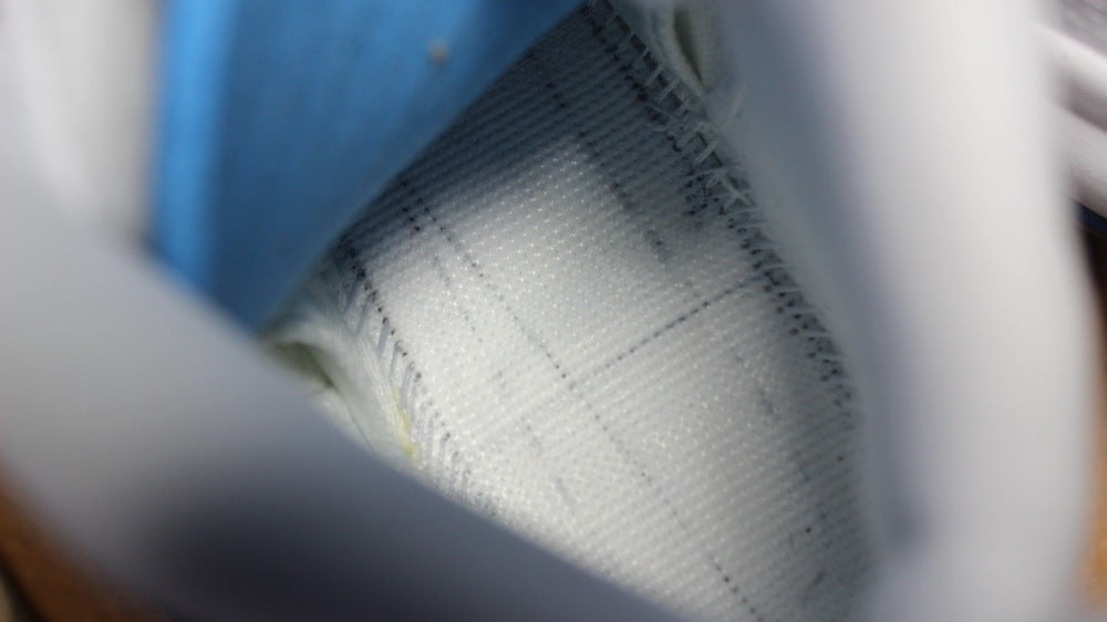 Close-up of the light-colored textured inner shoe panel.