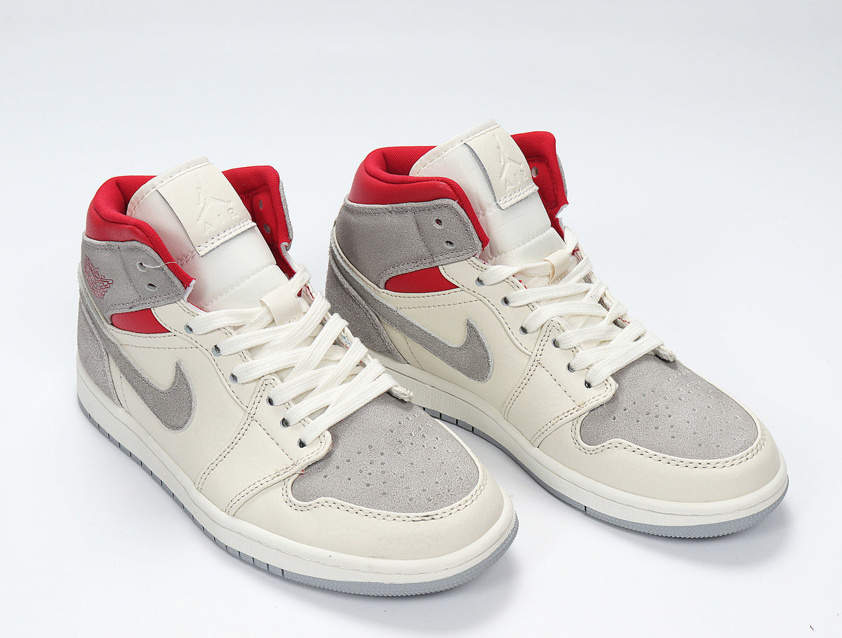 Angled view of the pair showing the grey, white and red color blocking and high-top design.