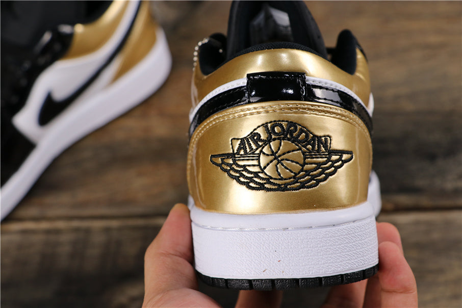 Rear view showing the metallic gold heel, black winged basketball emblem, white midsole and black outsole.