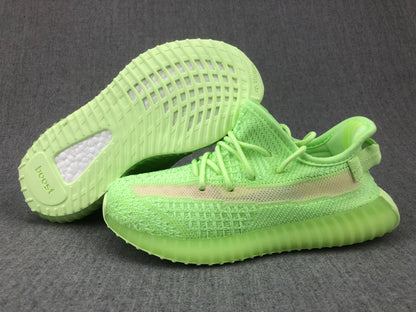 Sneakers shown with one outsole facing upward, revealing the patterned tread and visible Boost lettering.