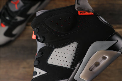 Close-up of the black upper, perforated grey side panel, red lace detail, and heel air unit.