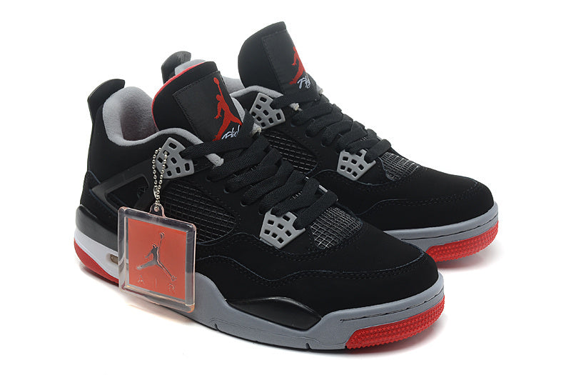 Pair of sneakers with black uppers, grey details, red outsoles and attached hangtag.