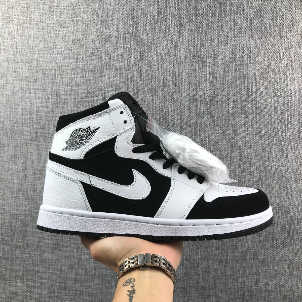 Side view of a black-and-white Jordan Air Jordan 1 high-top sneaker
