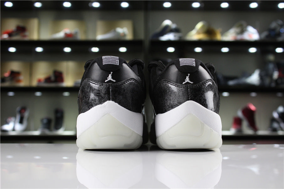 Straight rear view showing the heel logos, black upper panels, white midsoles, and translucent heel outsoles.