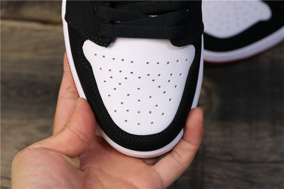 Close-up of the perforated white toe box framed by black overlays.