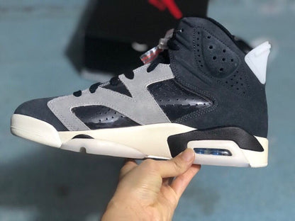 Side profile of one sneaker showing perforated panels, black and grey upper sections, a white midsole, and a visible heel air unit.