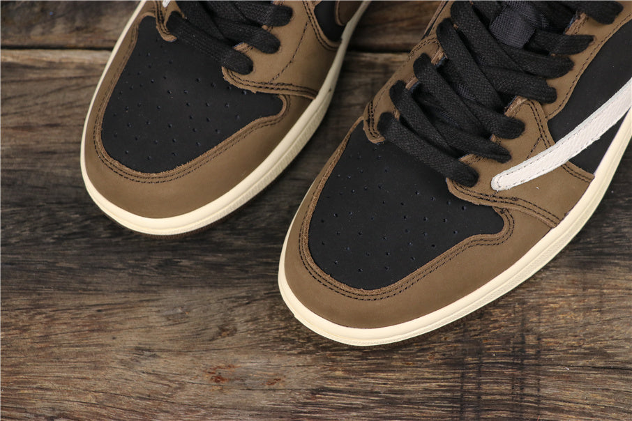 Top view of the perforated black toe boxes framed by dark mocha overlays and cream midsoles.