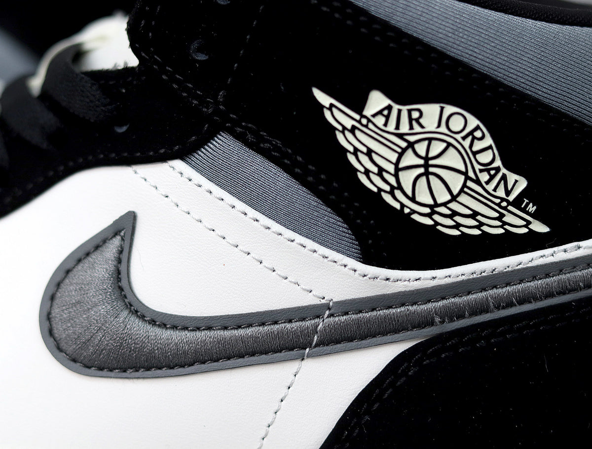 Close-up of the black, white and grey sneaker showing the Swoosh and Air Jordan winged logo.