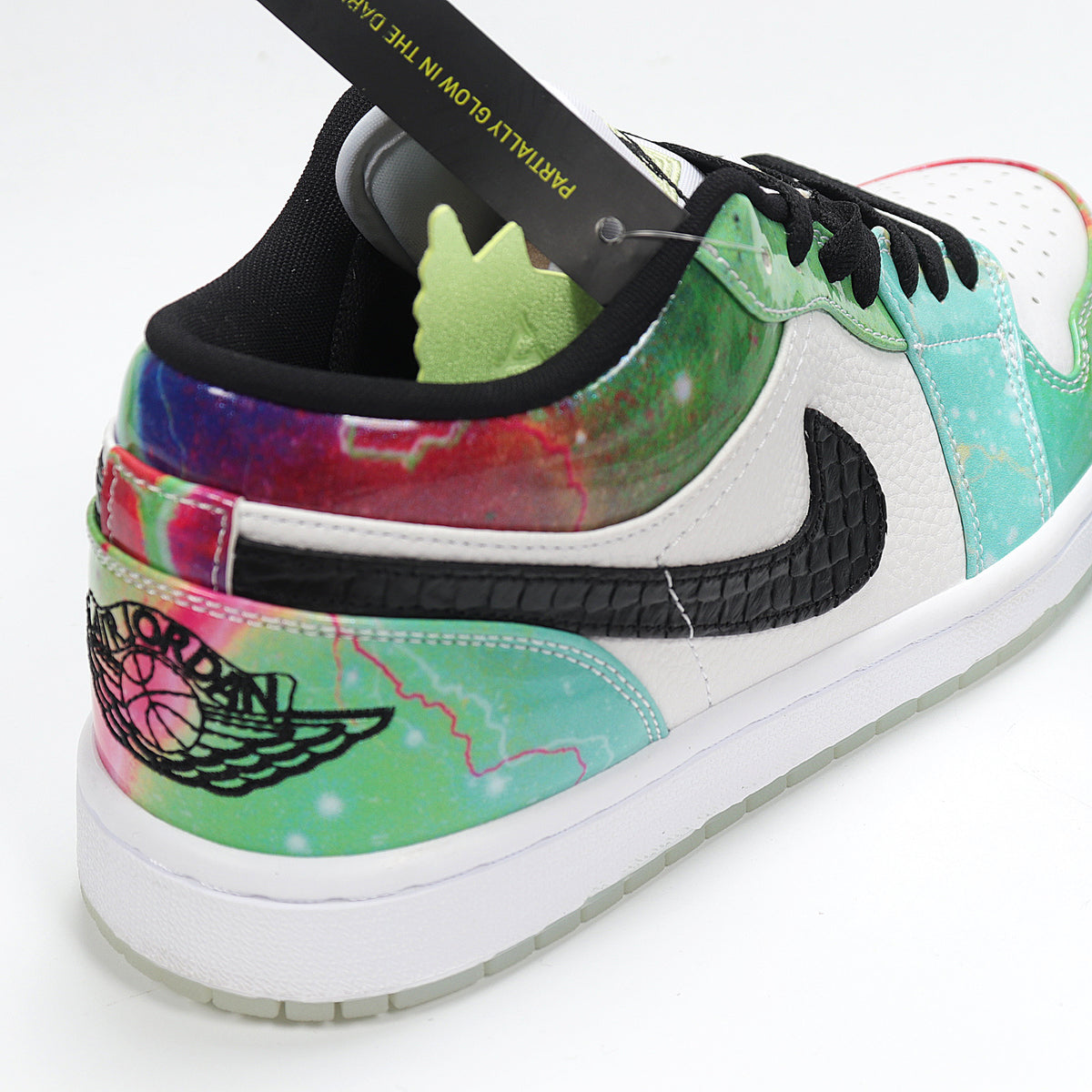 Close-up of the heel and side showing colorful graphic panels, a black logo, and a white midsole.