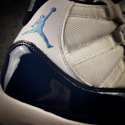 Close-up of the blue Jumpman logo, white upper panel, mesh fabric, and navy overlay.