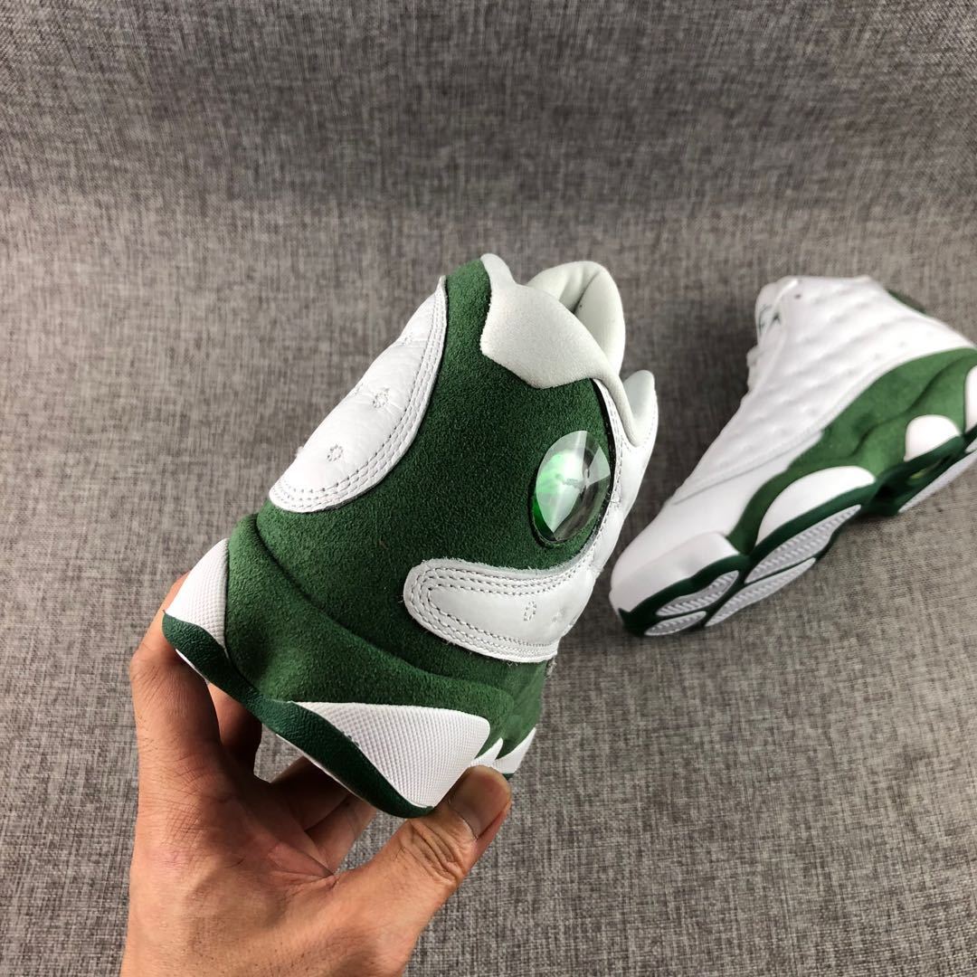 Rear three-quarter view highlighting the green heel panel, white heel overlays, and translucent circular detail.