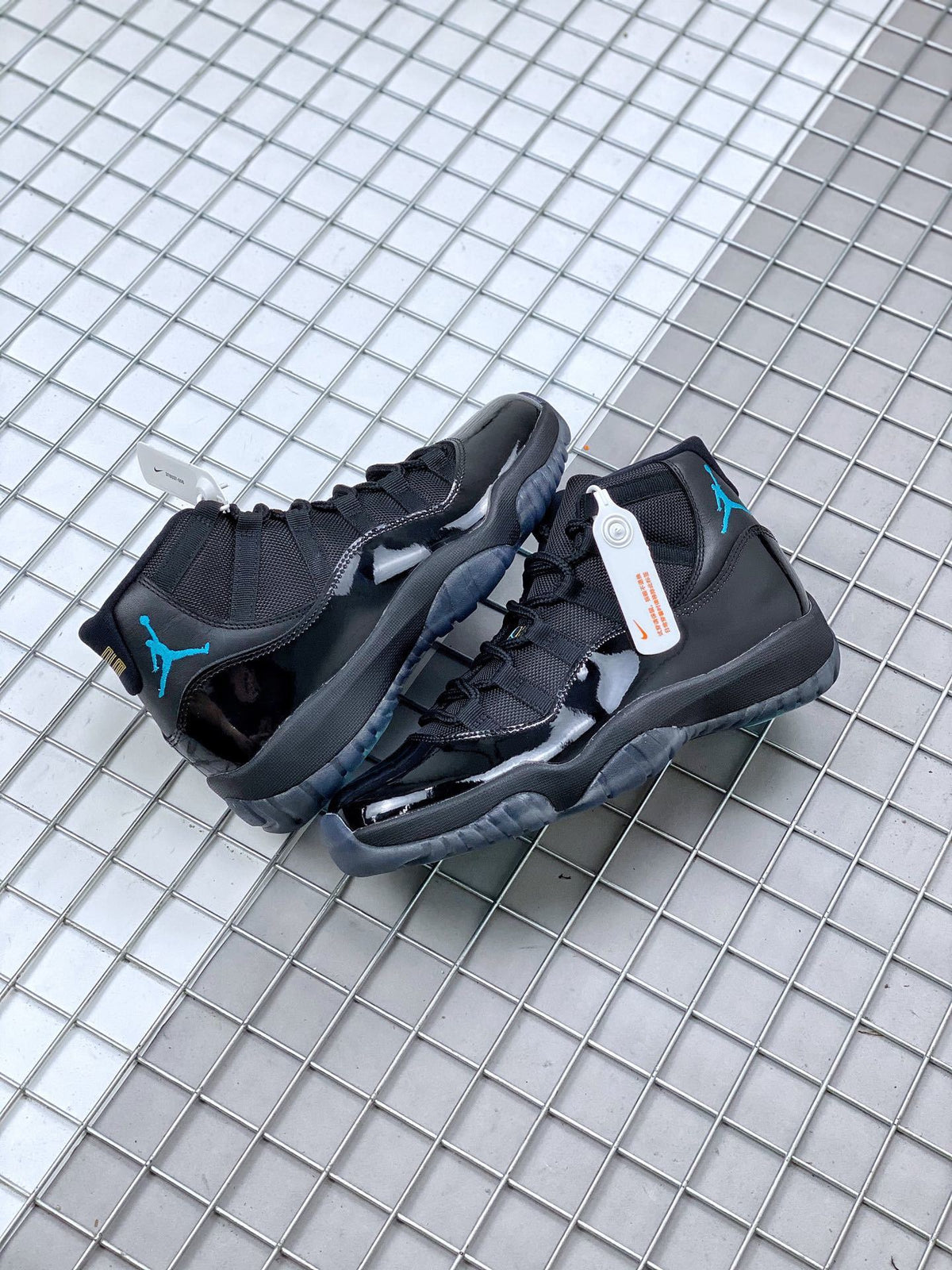 Pair of black sneakers shown together from the rear and side, with blue ankle and outsole accents.