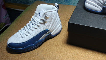 Angled view of one sneaker showing its laces, tongue, and navy side overlay.