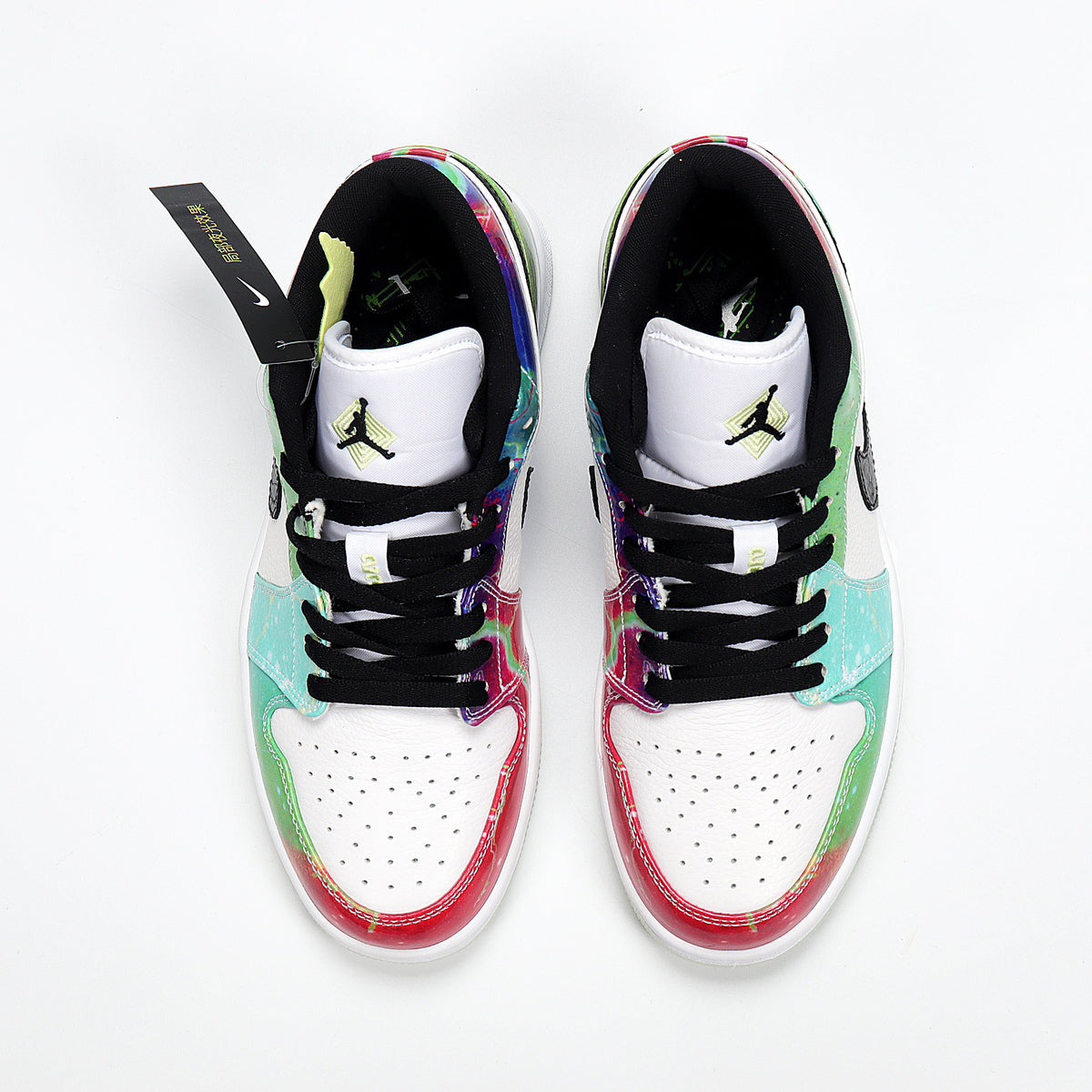 Top view of the pair showing white perforated toes, black laces, and colorful overlays.