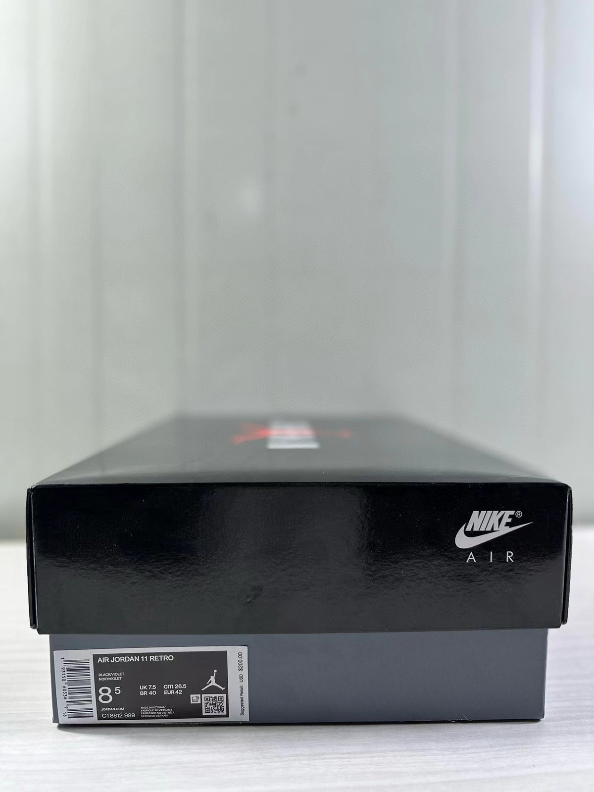 Black Nike Air shoebox with a label identifying Air Jordan 11 Retro, style code CT8812-999, and sample size 8.5.