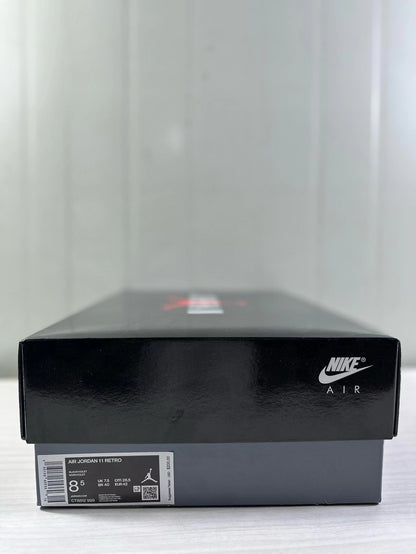 Black Nike Air shoebox with a label identifying Air Jordan 11 Retro, style code CT8812-999, and sample size 8.5.