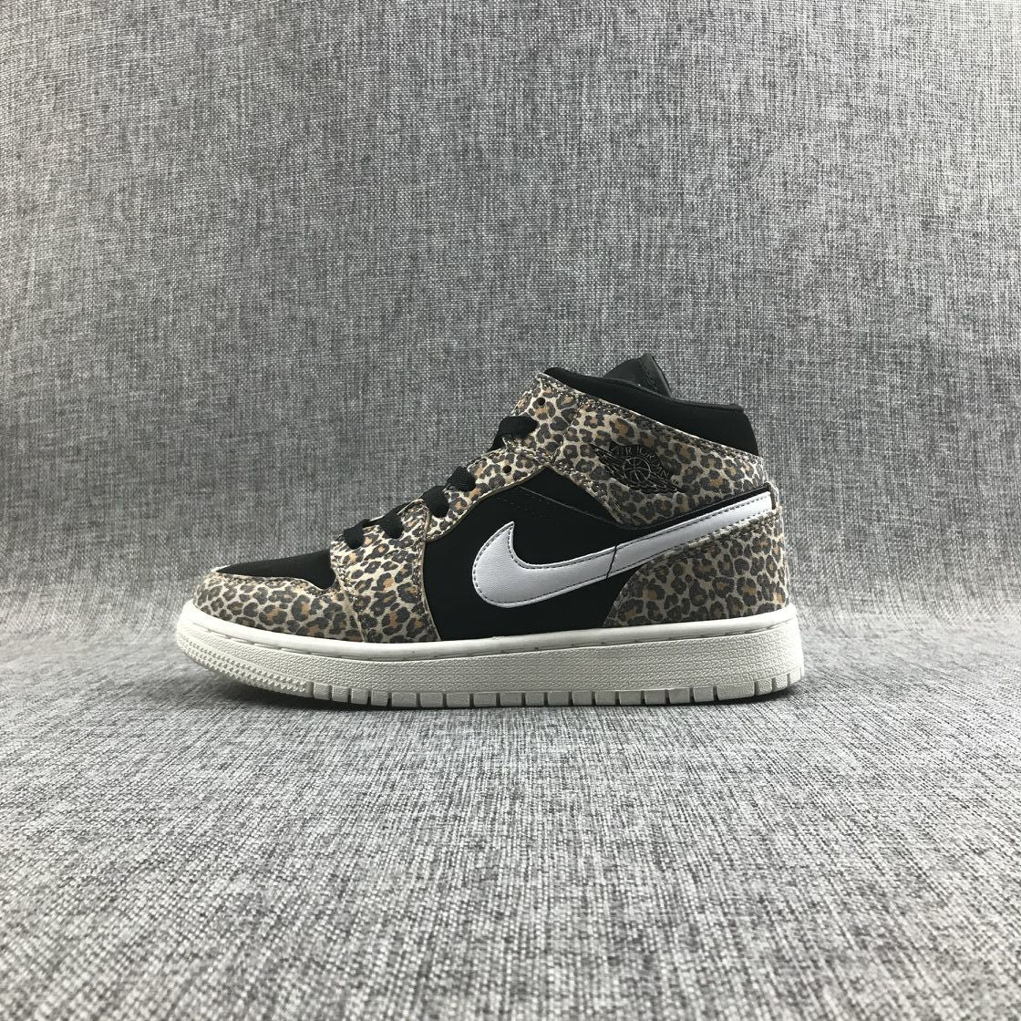 Side profile of the leopard-print mid-top sneaker with black panels and a white rubber outsole.