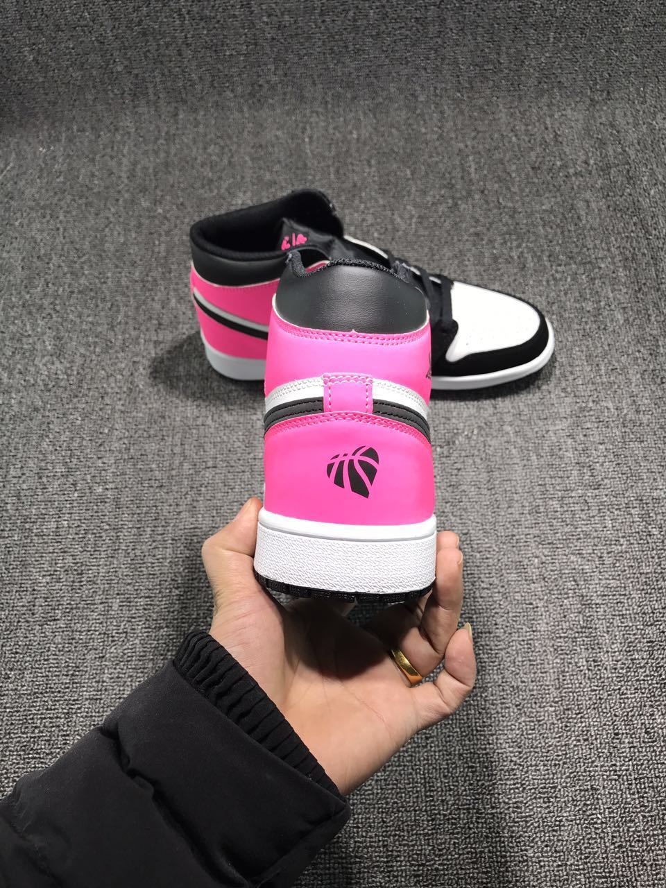 Rear view showing the vivid pink heel panel, black collar, white midsole, and Jordan-style heel emblem.