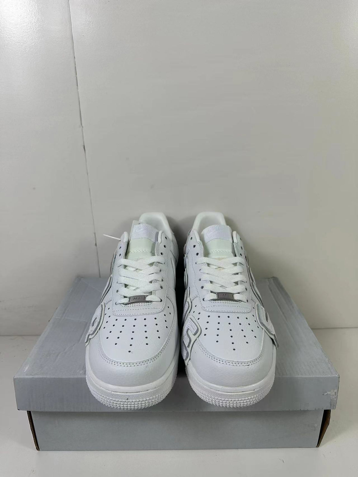 Front view showing the perforated white toe boxes, laces, and low-top silhouette.