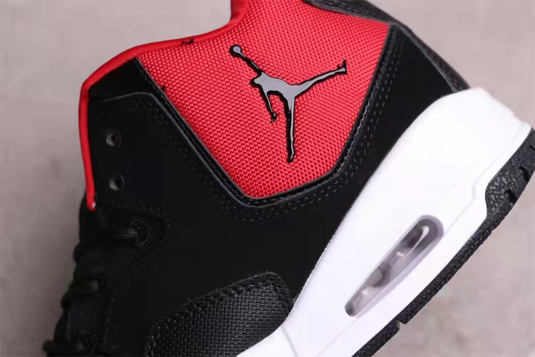 Close-up of the black and red upper, Jordan tongue logo, and white midsole window.