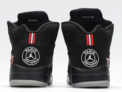 Rear view of the sneakers showing Paris Saint-Germain heel emblems and red-white stripes