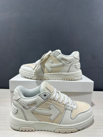 Two cream-white sneakers shown from side and three-quarter angles, highlighting layered panels and arrow motifs.