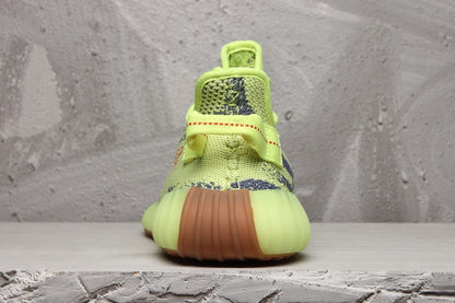 Rear view showing the padded heel, rear pull tab, and gum-colored outsole.