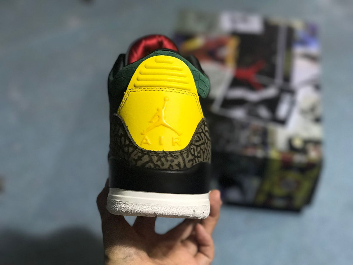Rear view showing a yellow heel panel, green collar detail, and patterned heel overlay.
