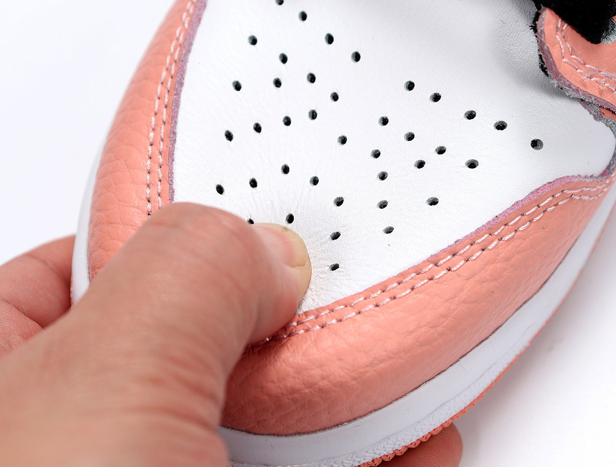Close-up of the white perforated toe panel and quartz pink stitched overlays.