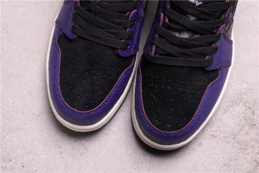 Close-up of the black perforated toe boxes with purple overlays and white midsoles.