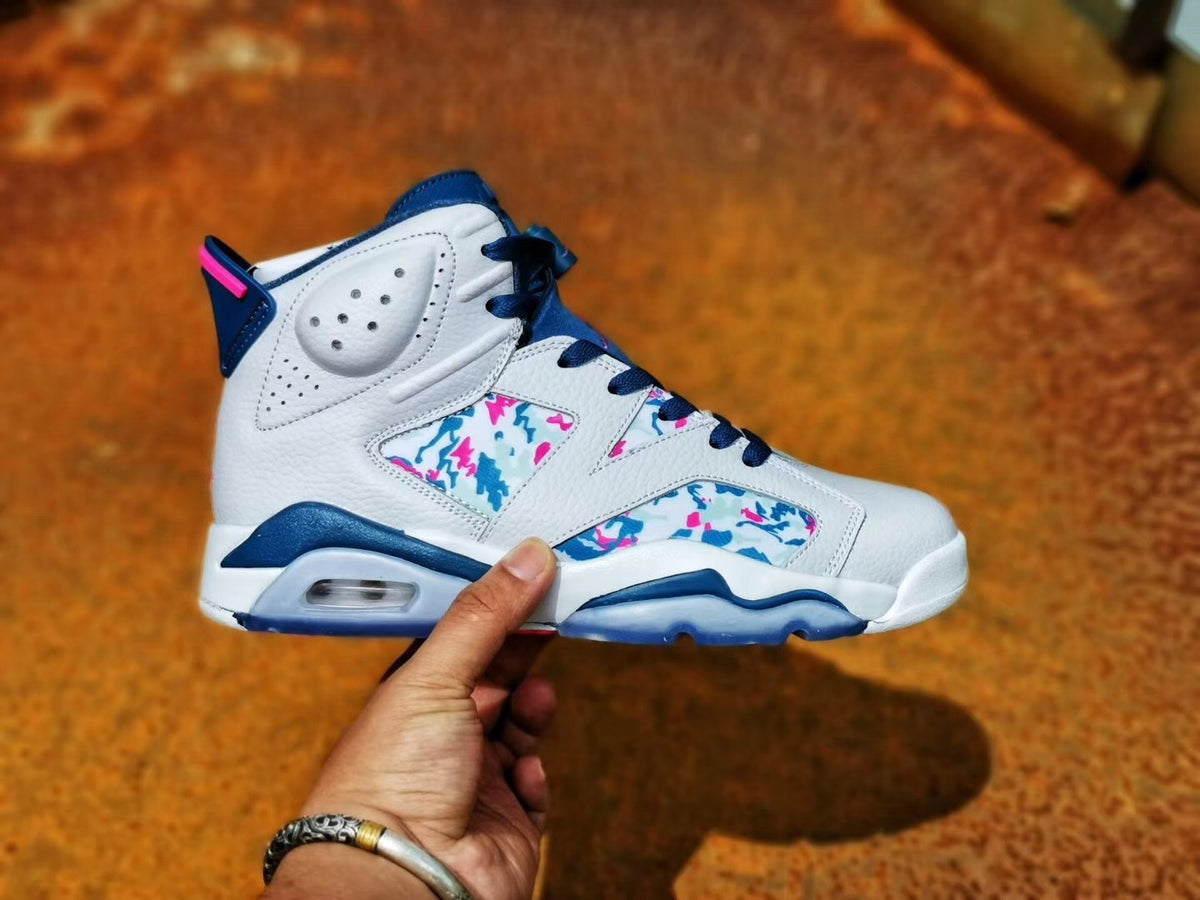 Opposite side profile showing the white upper, blue laces and trim, and colorful abstract patterned panels.