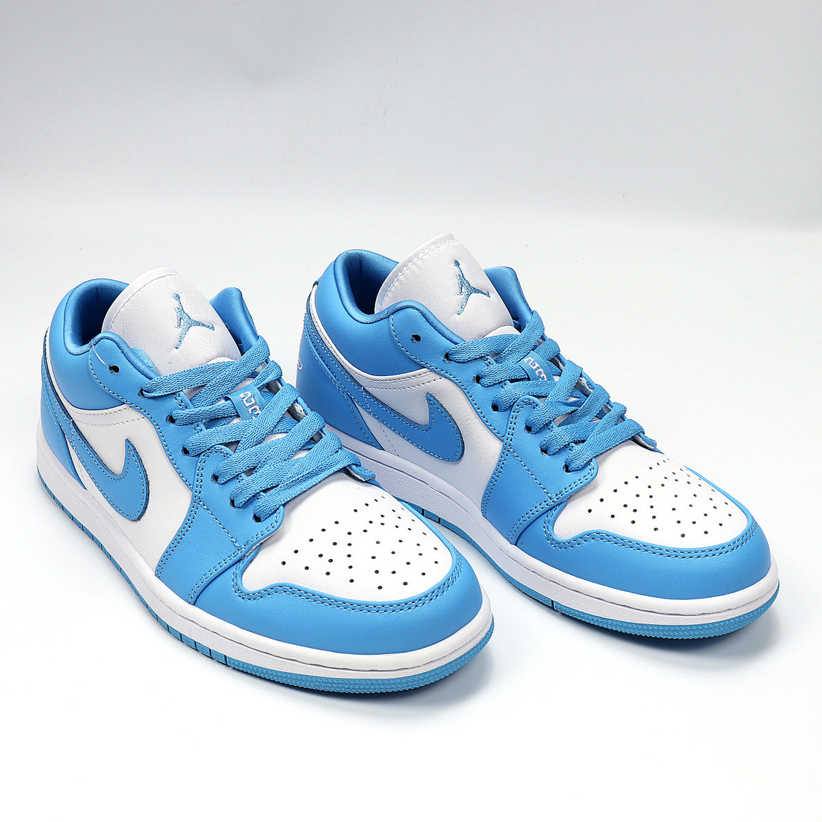 Three-quarter view of the blue and white Jordan low-top sneaker pair.