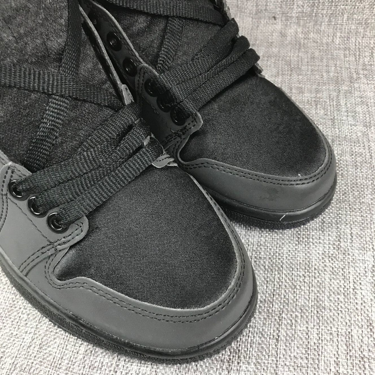 Close-up of the black textile toe boxes, matching overlays, and lace detail.
