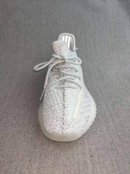 Front-top view showing the laces, knit-look upper, reflective-looking tongue area, and rounded toe.